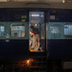 An Indian Railways employee works to convert a train coach into an isolation ward.